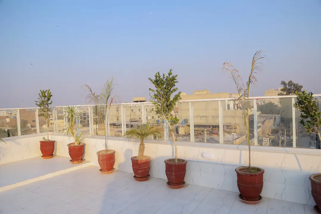 Rooftop terrace with potted plants at Rabia Hall Branch 1