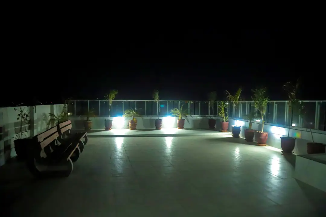 Rooftop terrace lit up at night at Rabia Hall Branch 1