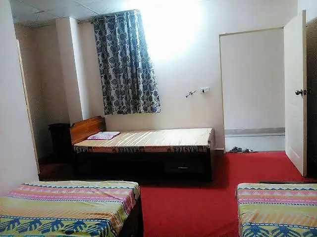 Carpeted shared room with beds at Rabia Hall Branch 2